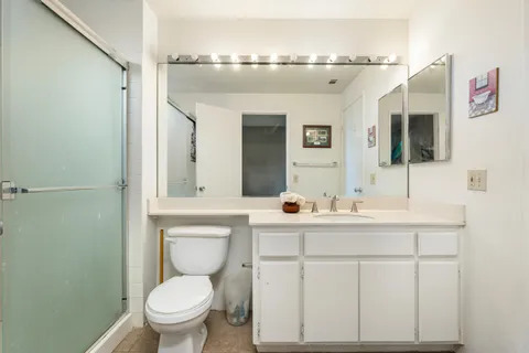 a bathroom with a toilet sink and mirror