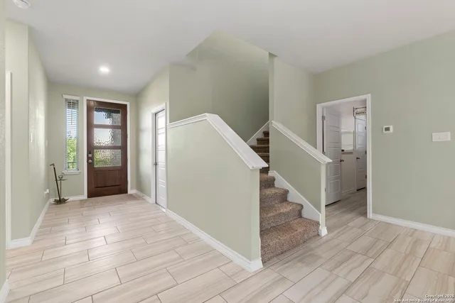 a view of a hallway with wooden floor and entryway