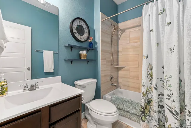 a bathroom with a sink a toilet and a shower