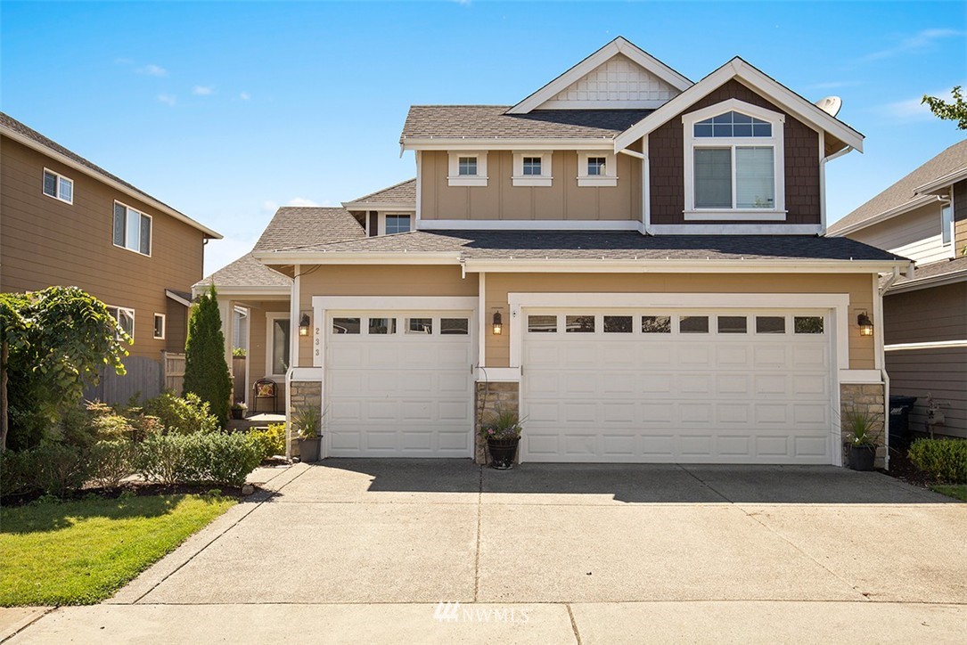 233 Chelan Avenue Northeast Renton, WA 98059 - Photo 1 of 16 a front view of a house with a yard and garage