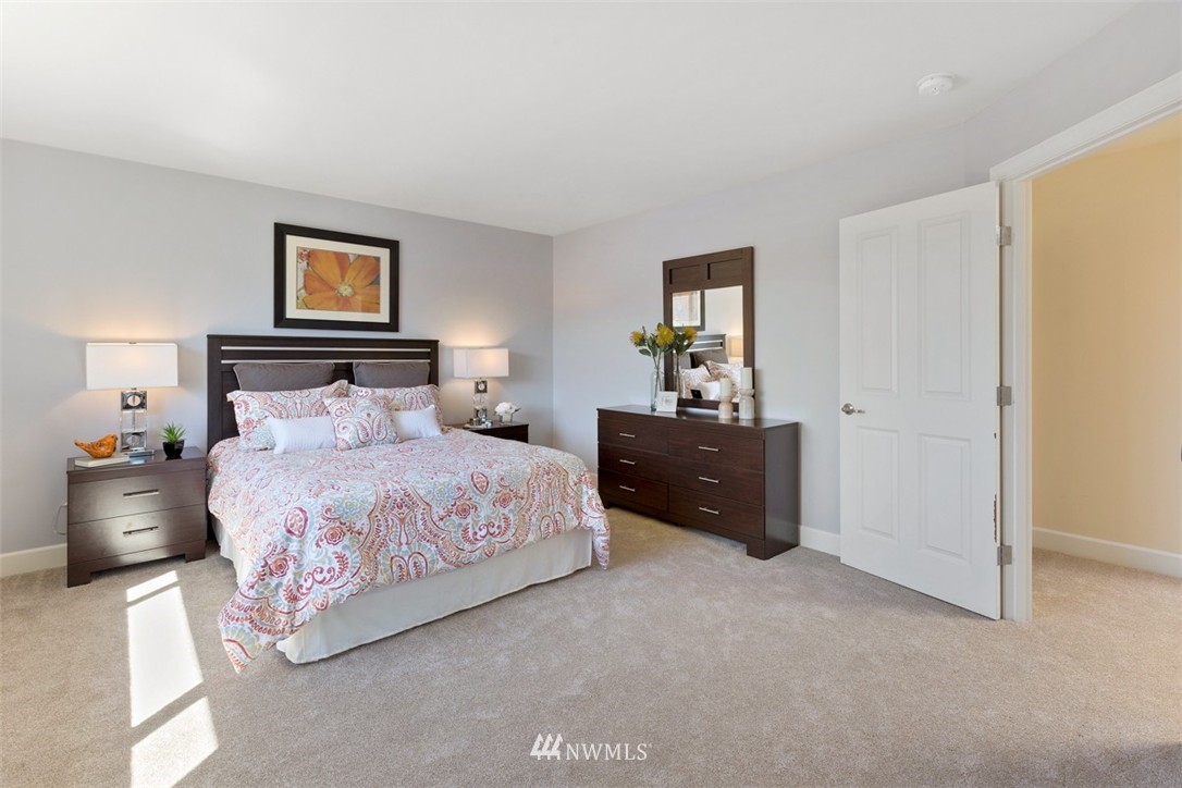 233 Chelan Avenue Northeast Renton, WA 98059 - Photo 11 of 16 a bedroom with a bed and a painting on the wall