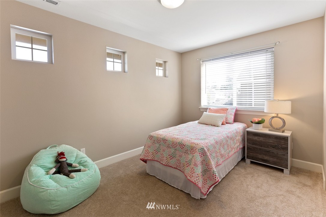 233 Chelan Avenue Northeast Renton, WA 98059 - Photo 13 of 16 a bedroom with a bed and a window