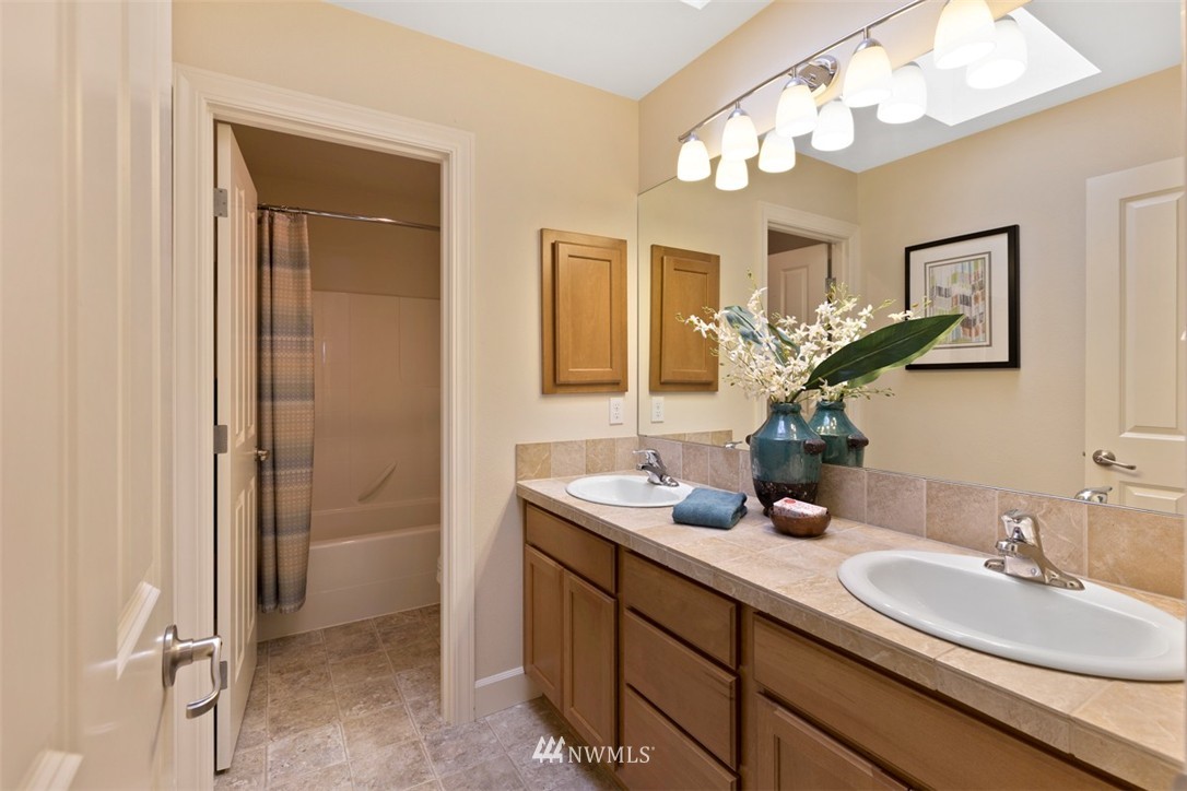 233 Chelan Avenue Northeast Renton, WA 98059 - Photo 14 of 16 a bathroom with a double vanity sink and a mirror
