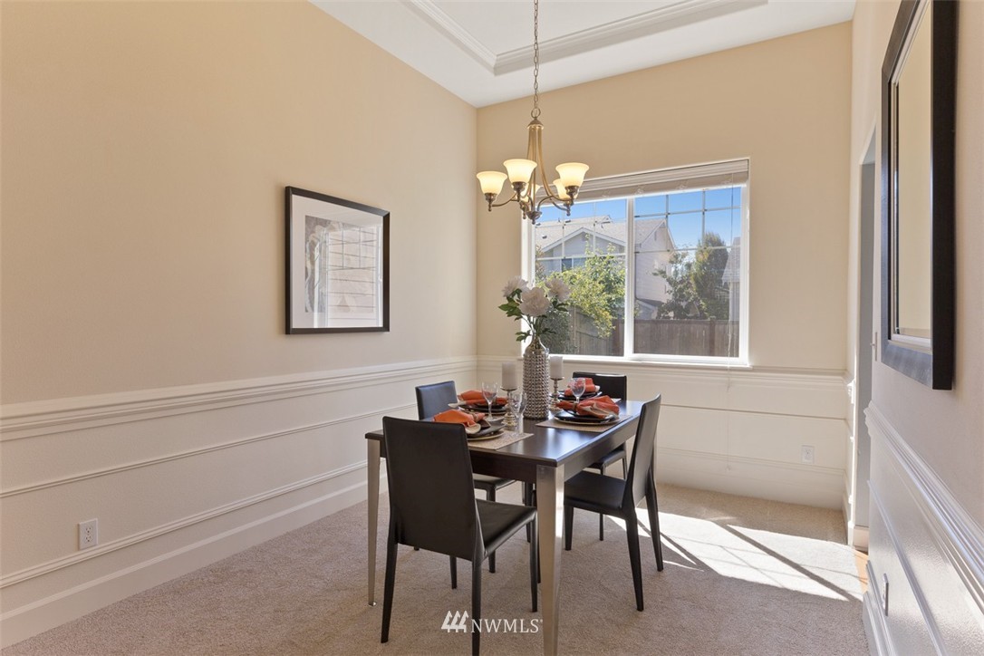233 Chelan Avenue Northeast Renton, WA 98059 - Photo 6 of 16 a dining room with furniture a chandelier and window