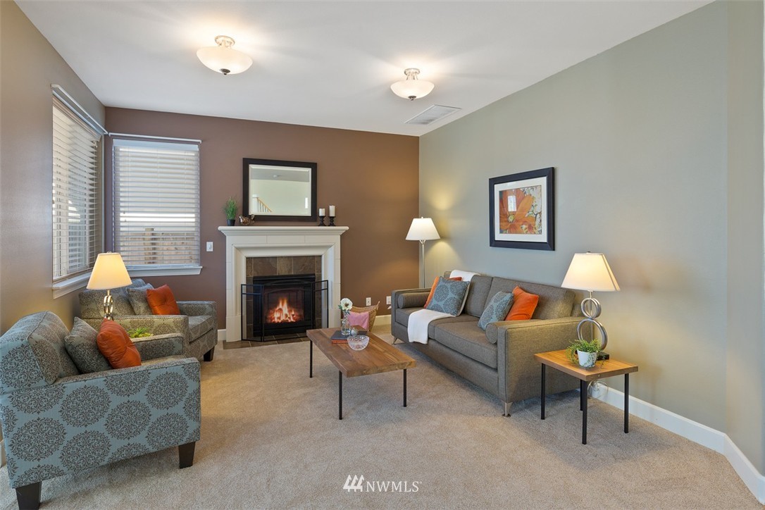 233 Chelan Avenue Northeast Renton, WA 98059 - Photo 7 of 16 a living room with furniture and a fireplace