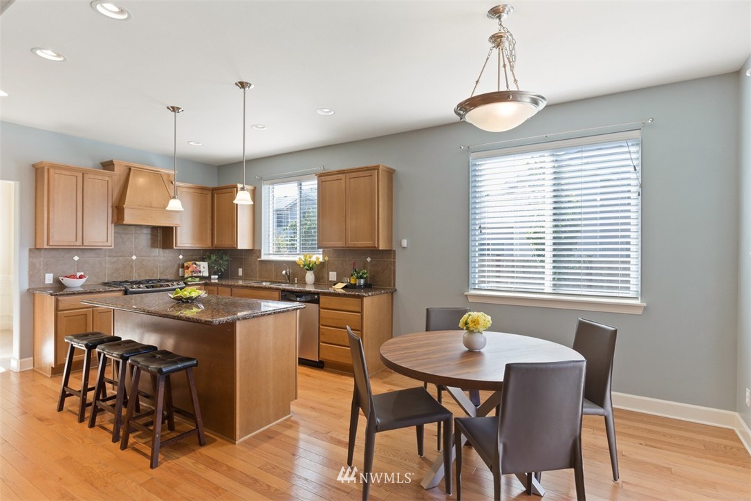 233 Chelan Avenue Northeast Renton, WA 98059 - Photo 9 of 16 a kitchen with a dining table chairs and sink