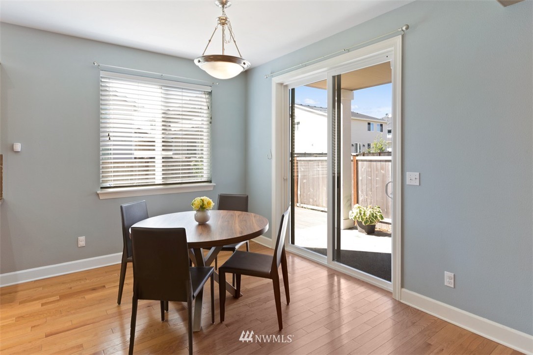 233 Chelan Avenue Northeast Renton, WA 98059 - Photo 10 of 16 a dining room with wooden floor and a chandelier