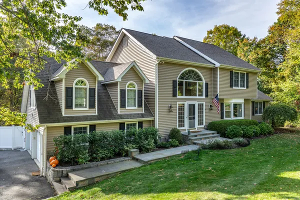 a front view of a house with a yard