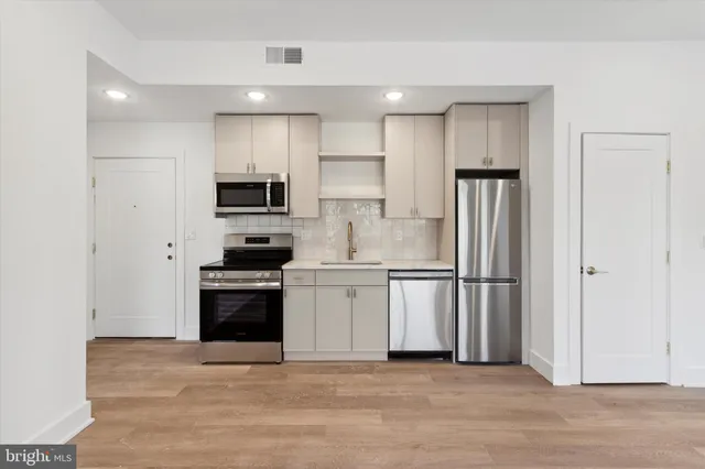 a kitchen with a refrigerator stove and microwave