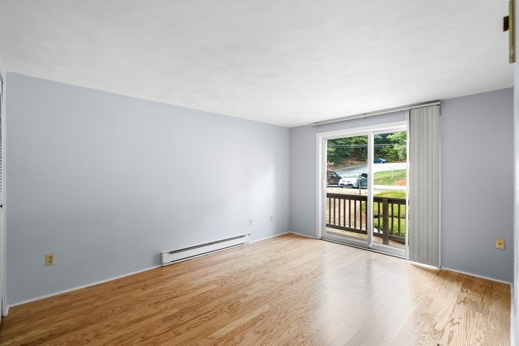 7 Wampus Avenue, Unit 15 Acton, MA 01720 - Photo 13 of 30 a view of a room with wooden floor and fence