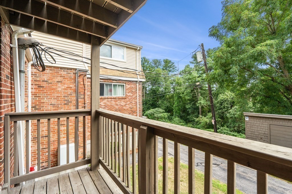 7 Wampus Avenue, Unit 15 Acton, MA 01720 - Photo 18 of 30 a view of a balcony with wooden floor