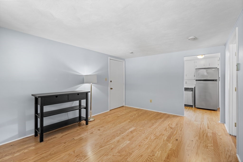 7 Wampus Avenue, Unit 15 Acton, MA 01720 - Photo 5 of 30 a view of empty room with wooden floor and cabinet