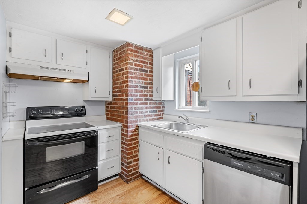 7 Wampus Avenue, Unit 15 Acton, MA 01720 - Photo 7 of 30 a kitchen with granite countertop a stove sink and cabinets