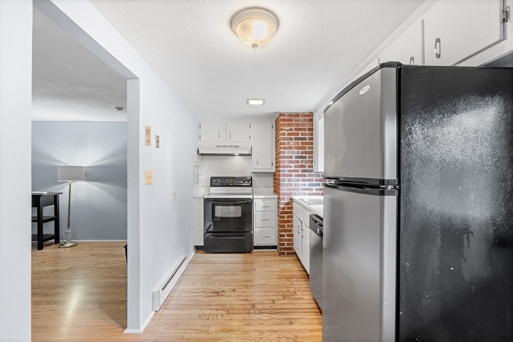 7 Wampus Avenue, Unit 15 Acton, MA 01720 - Photo 8 of 30 a kitchen with a refrigerator and a stove