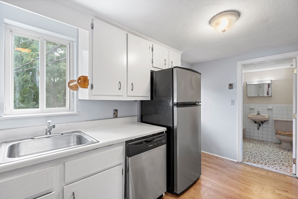 7 Wampus Avenue, Unit 15 Acton, MA 01720 - Photo 9 of 30 a kitchen with a sink and a refrigerator