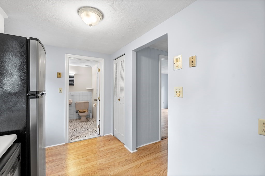 7 Wampus Avenue, Unit 15 Acton, MA 01720 - Photo 10 of 30 a view of a hallway with bathroom and wooden floor