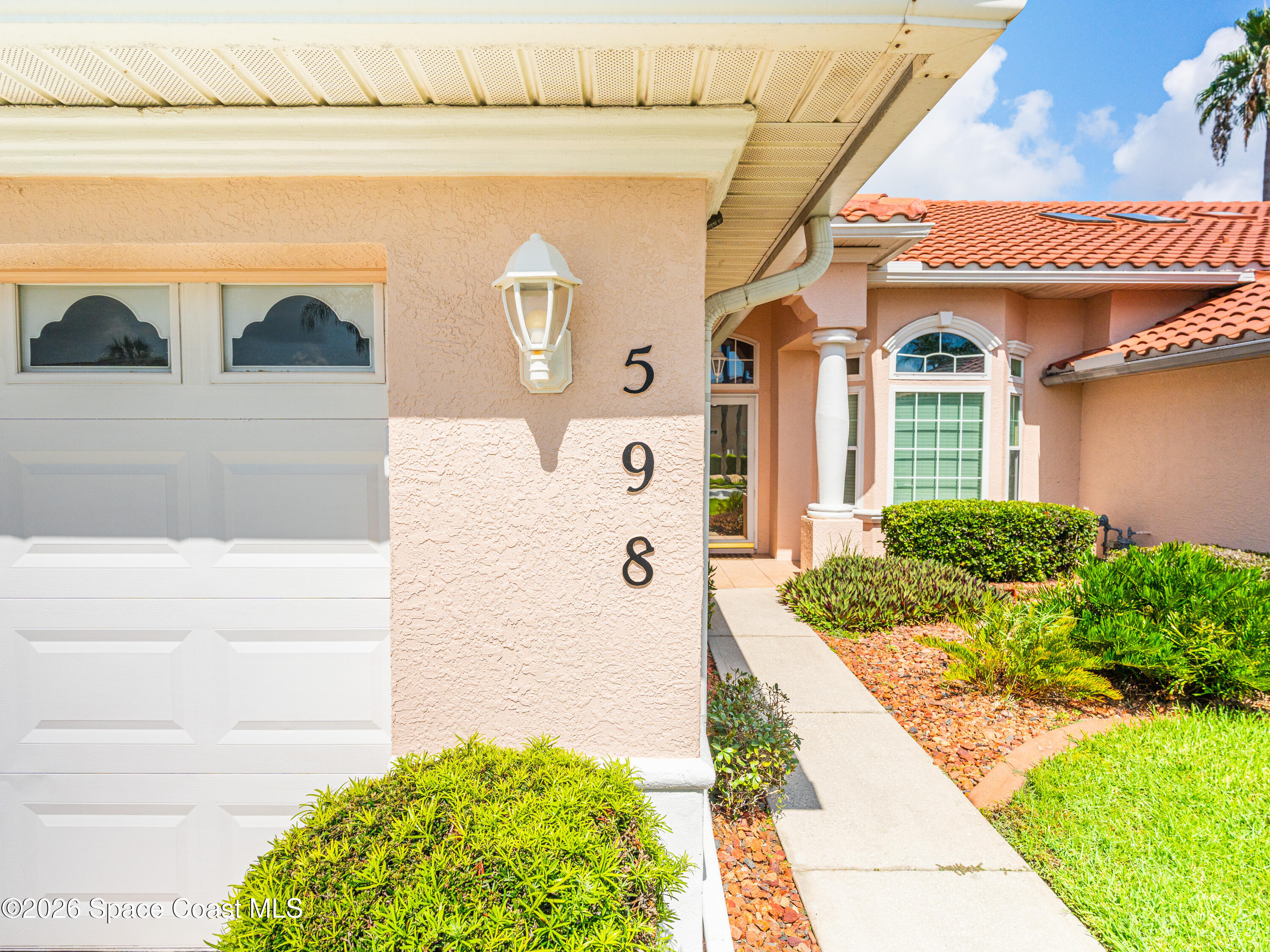 598 Renaissance Avenue Melbourne, FL 32940 - Photo 54 of 56 a front view of a house with garden