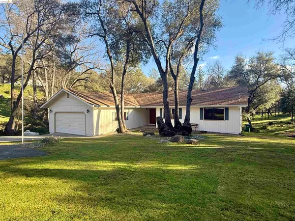 a house view with a sitting space and garden