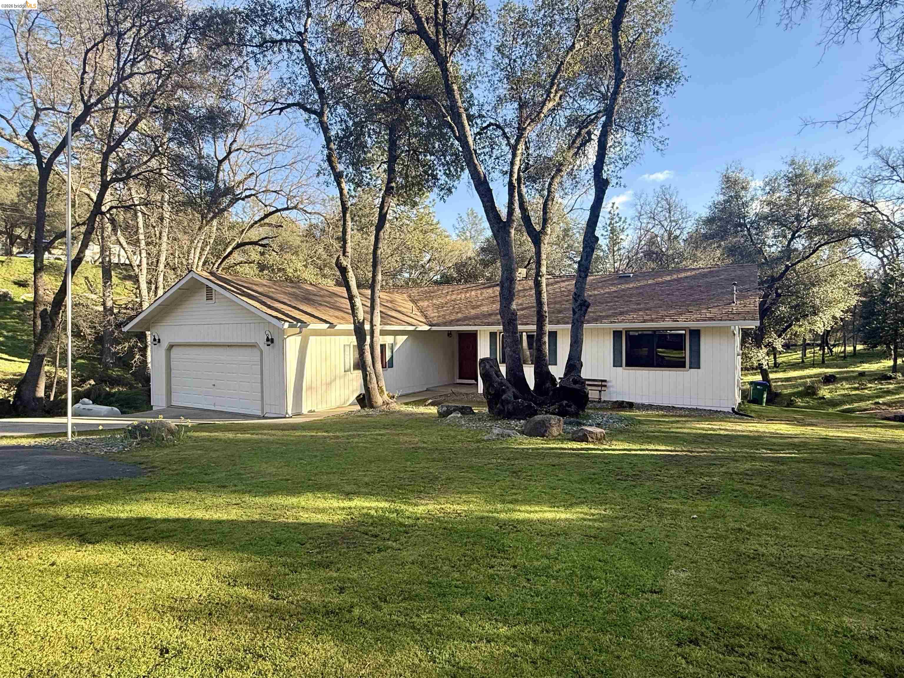 a house view with a sitting space and garden