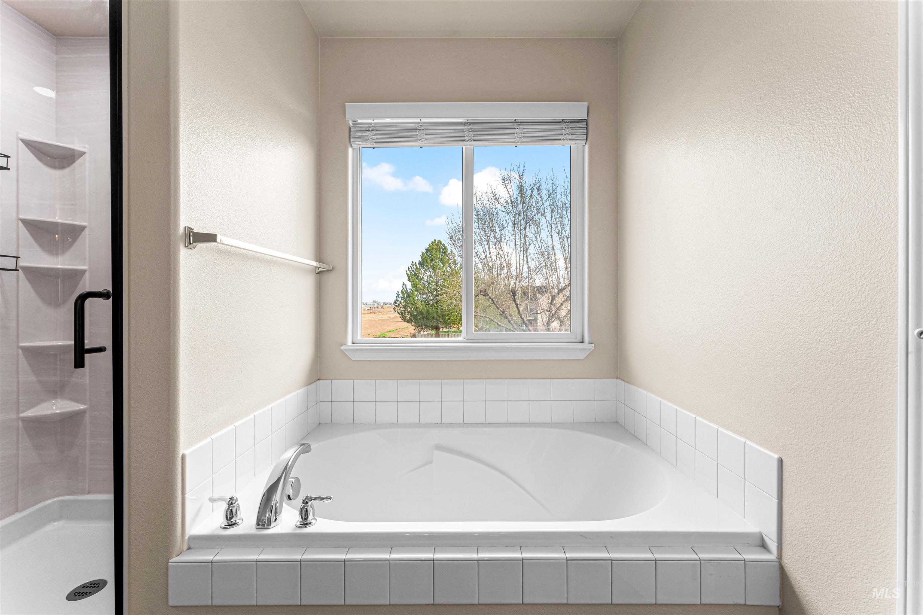 2503 Carnegie Street Caldwell, ID 83607 - Photo 12 of 20 Full bath with a shower stall, a textured wall, and a bath