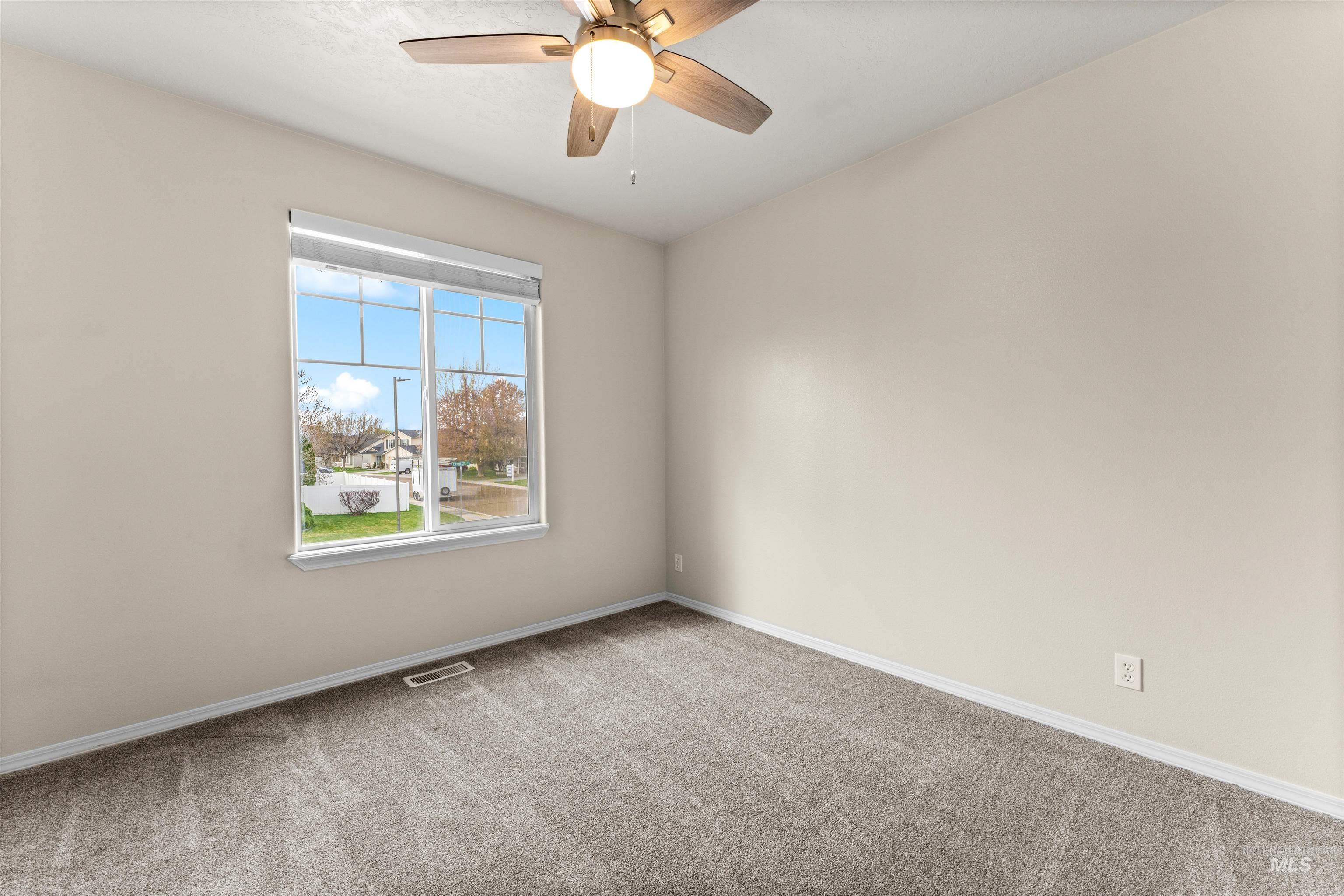 2503 Carnegie Street Caldwell, ID 83607 - Photo 14 of 20 Carpeted empty room with a ceiling fan and baseboards