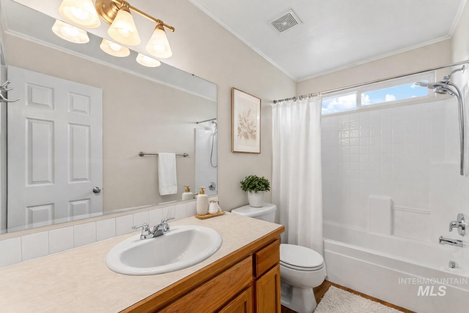 2503 Carnegie Street Caldwell, ID 83607 - Photo 15 of 20 Full bath with vanity, ornamental molding, and shower / bathtub combination with curtain