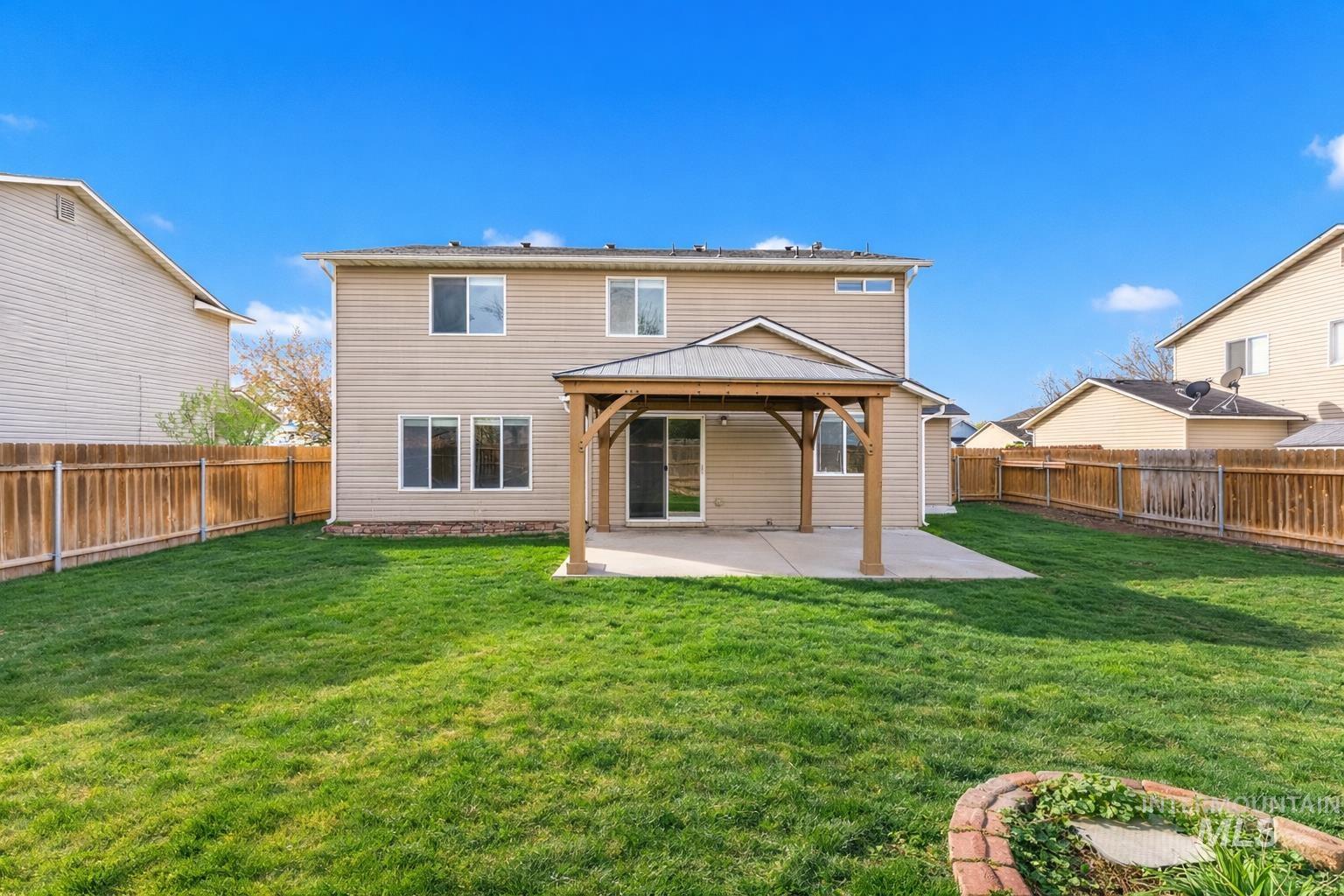 2503 Carnegie Street Caldwell, ID 83607 - Photo 19 of 20 Back of property featuring a gazebo, a patio area, and a fenced backyard