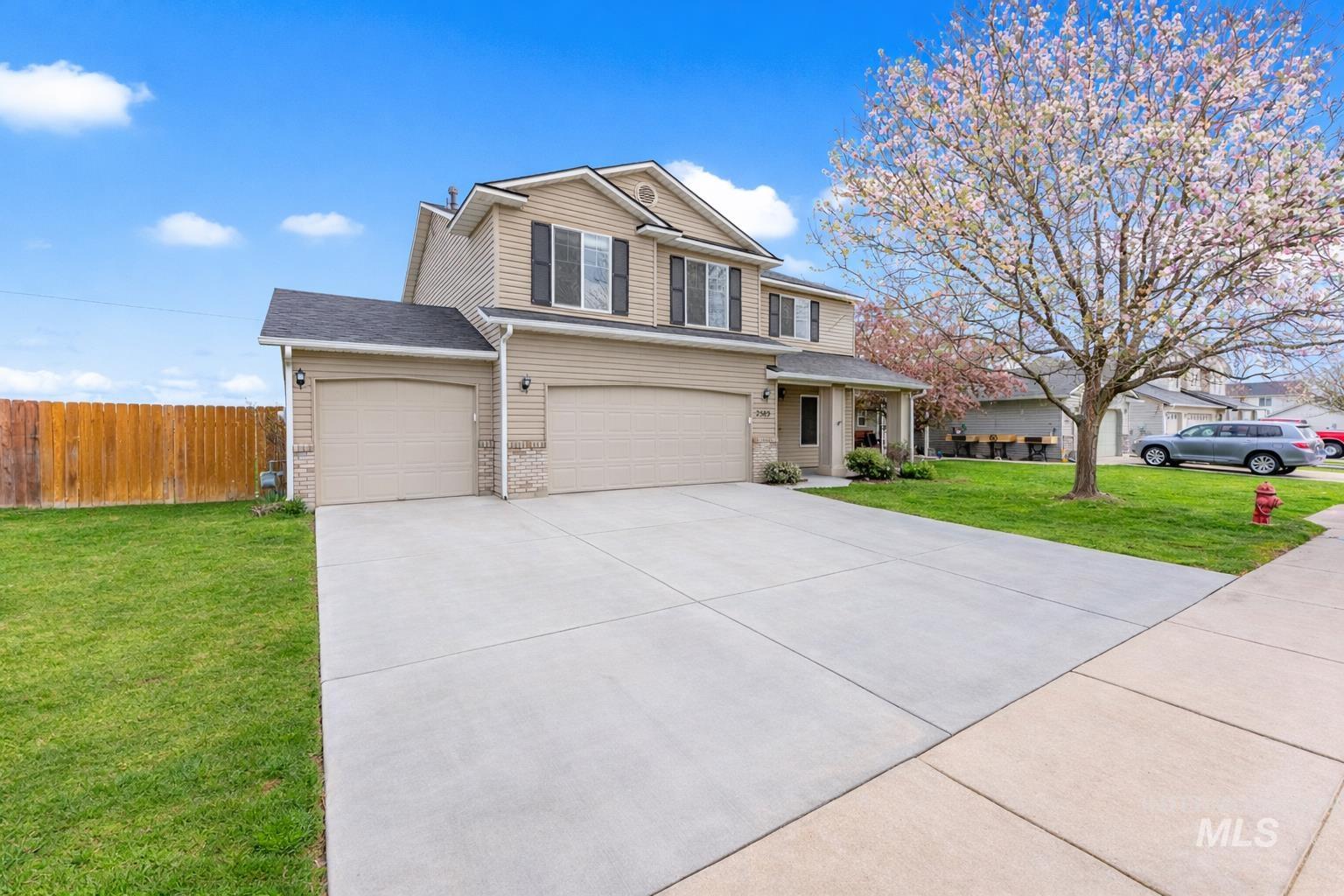 2503 Carnegie Street Caldwell, ID 83607 - Photo 20 of 20 View of front of property featuring driveway, an attached garage, a porch, brick siding, and a garage