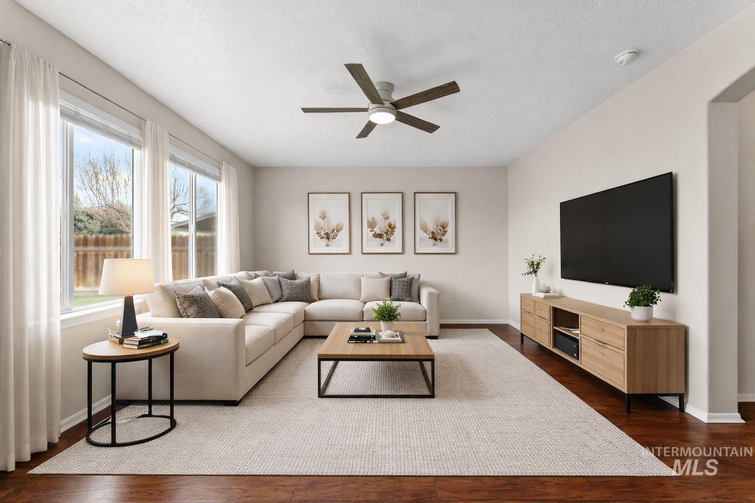 2503 Carnegie Street Caldwell, ID 83607 - Photo 4 of 20 Living area featuring dark wood-type flooring and ceiling fan
