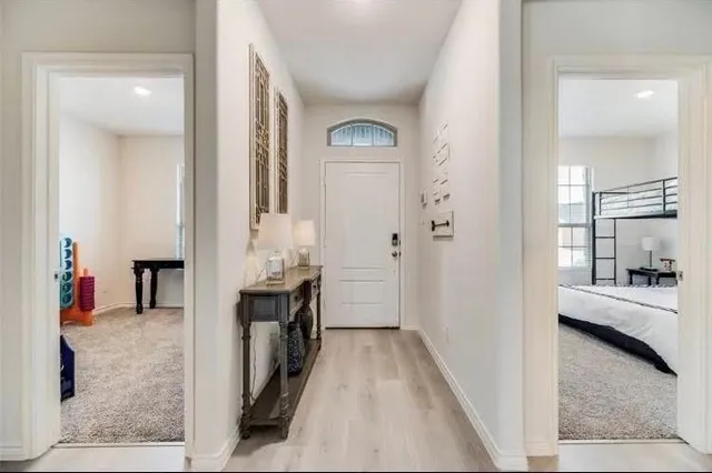 a view of a bathroom with tub mirror and window
