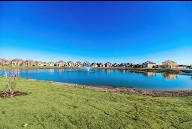 a view of a green field with sitting area