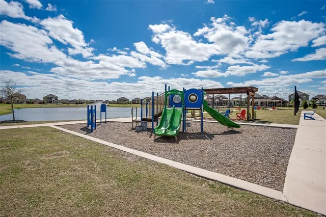 a view of a swimming pool with a yard