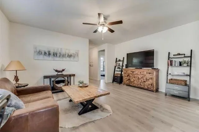 a living room with furniture and a flat screen tv