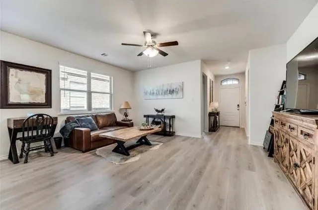 a living room with furniture and a flat screen tv