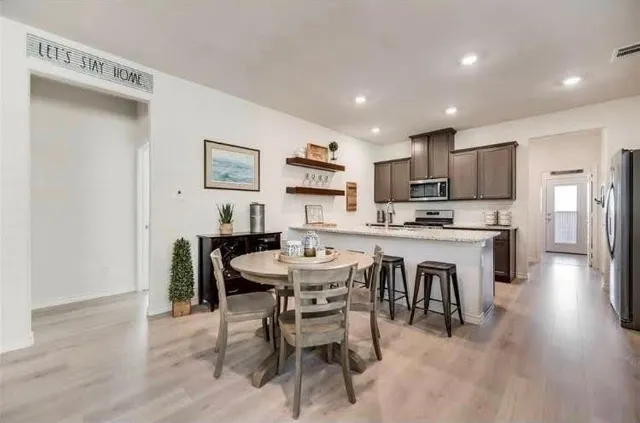 a view of kitchen with cabinets table and chairs