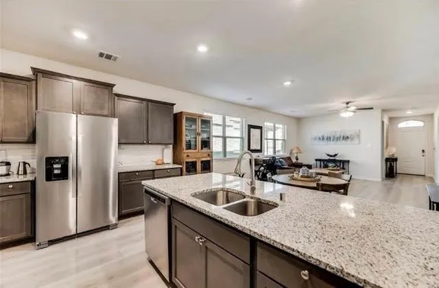 a kitchen with sink refrigerator and stove