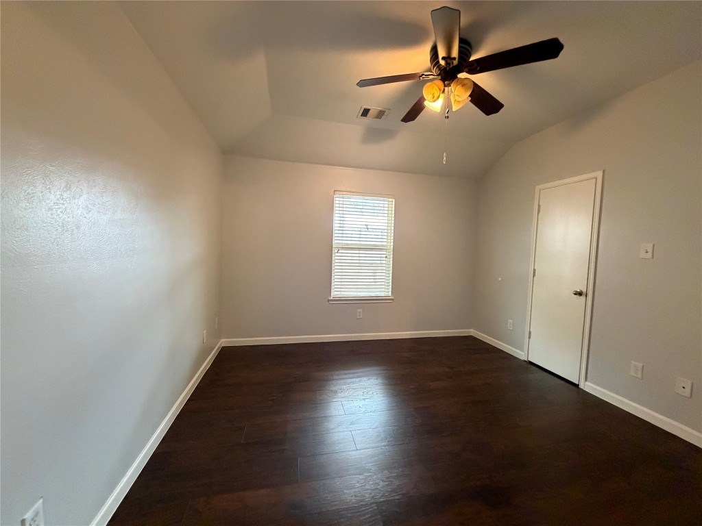 2902 Back Bay Brook Trail Houston, TX 77045 - Photo 8 of 11 a view of an empty room with window and wooden floor