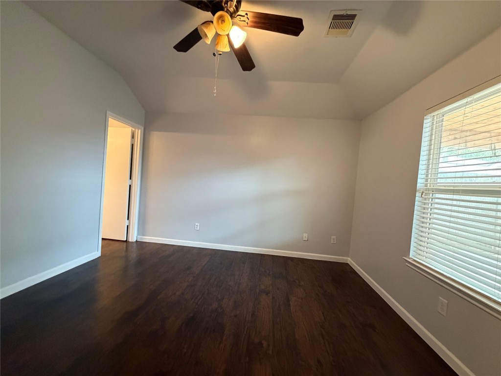 2902 Back Bay Brook Trail Houston, TX 77045 - Photo 10 of 11 an empty room with wooden floor and windows