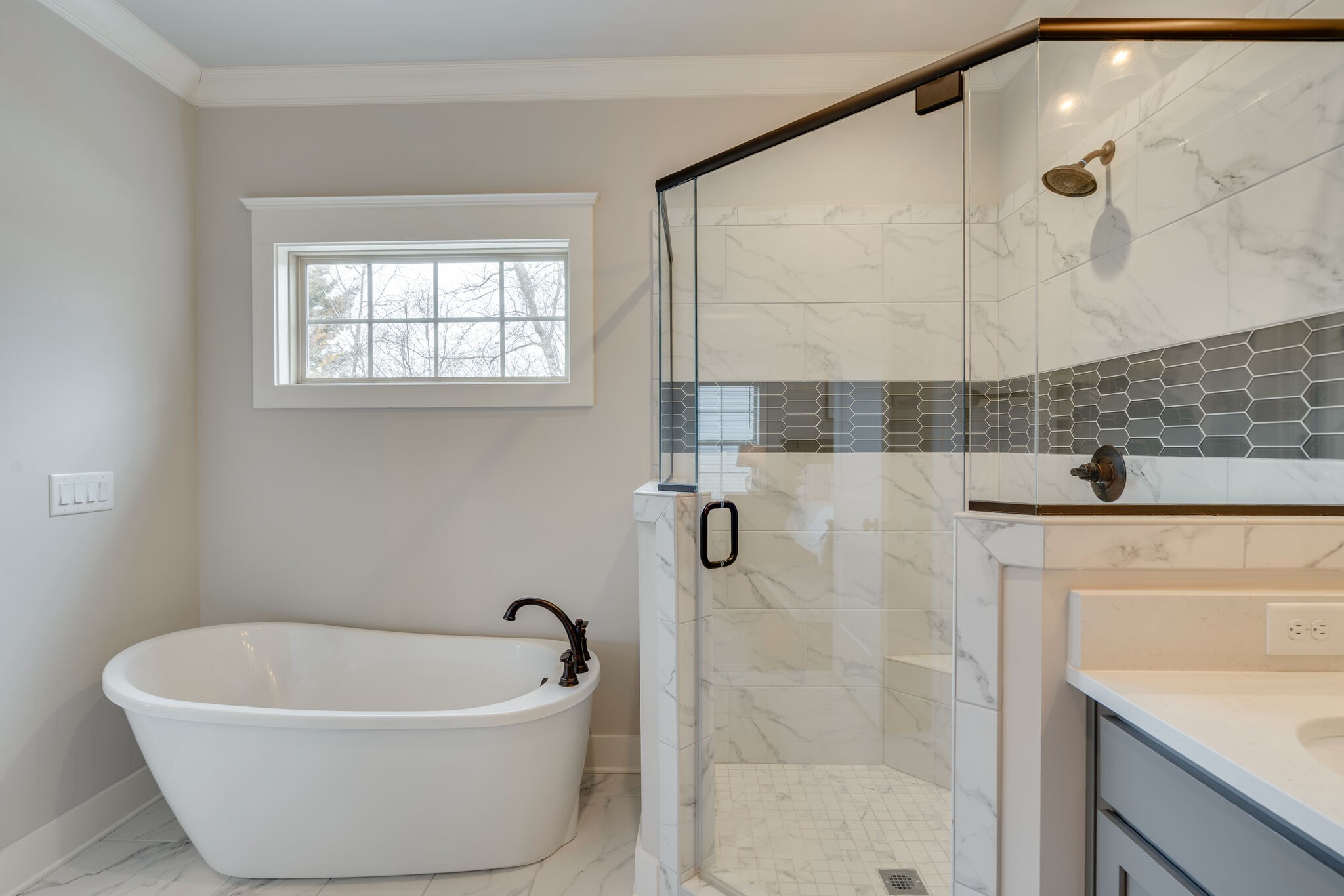 987 Carnation Drive Spring Hill, TN 37174 - Photo 12 of 26 a white bath tub sitting in a bathroom and shower
