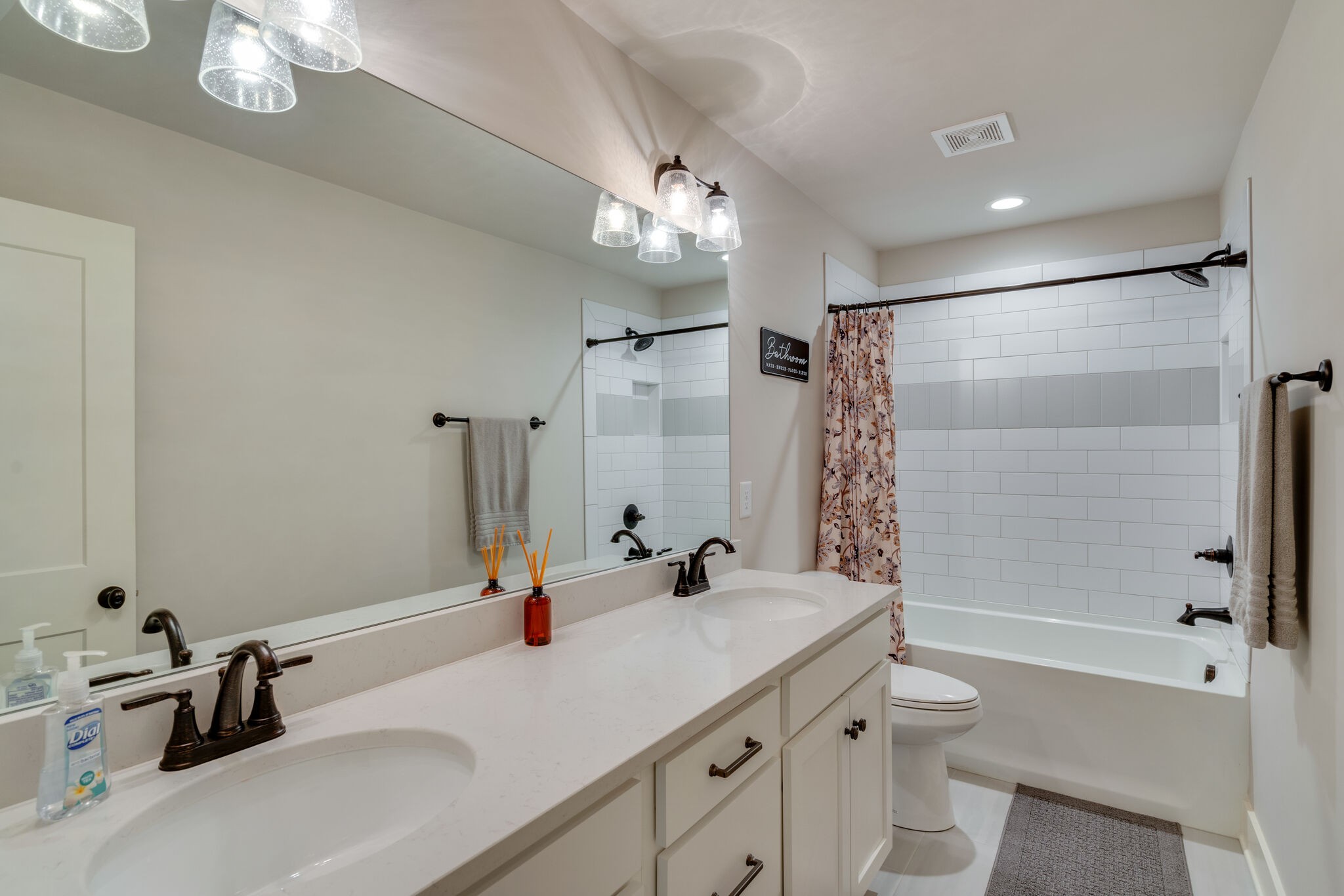987 Carnation Drive Spring Hill, TN 37174 - Photo 16 of 26 a bathroom with a tub sink toilet and a mirror