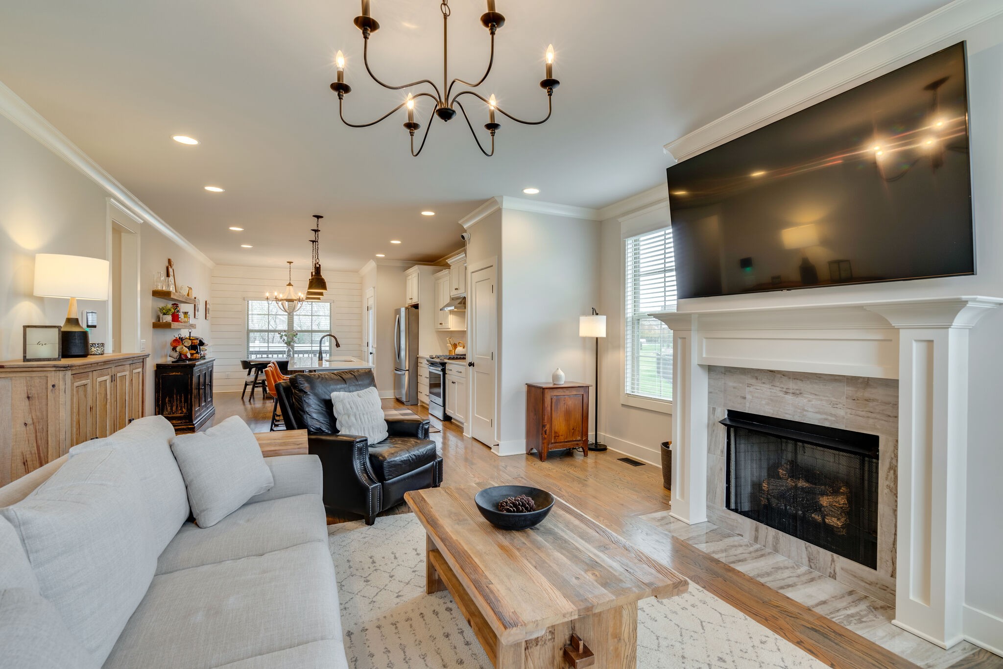 987 Carnation Drive Spring Hill, TN 37174 - Photo 3 of 26 a living room with furniture a flat screen tv and a fireplace