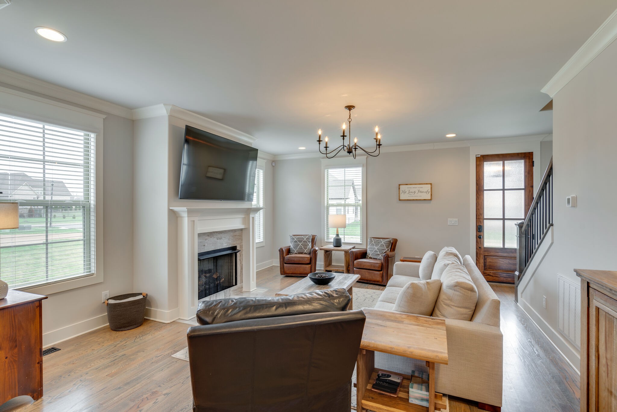 987 Carnation Drive Spring Hill, TN 37174 - Photo 5 of 26 a living room with furniture a fireplace and a flat screen tv