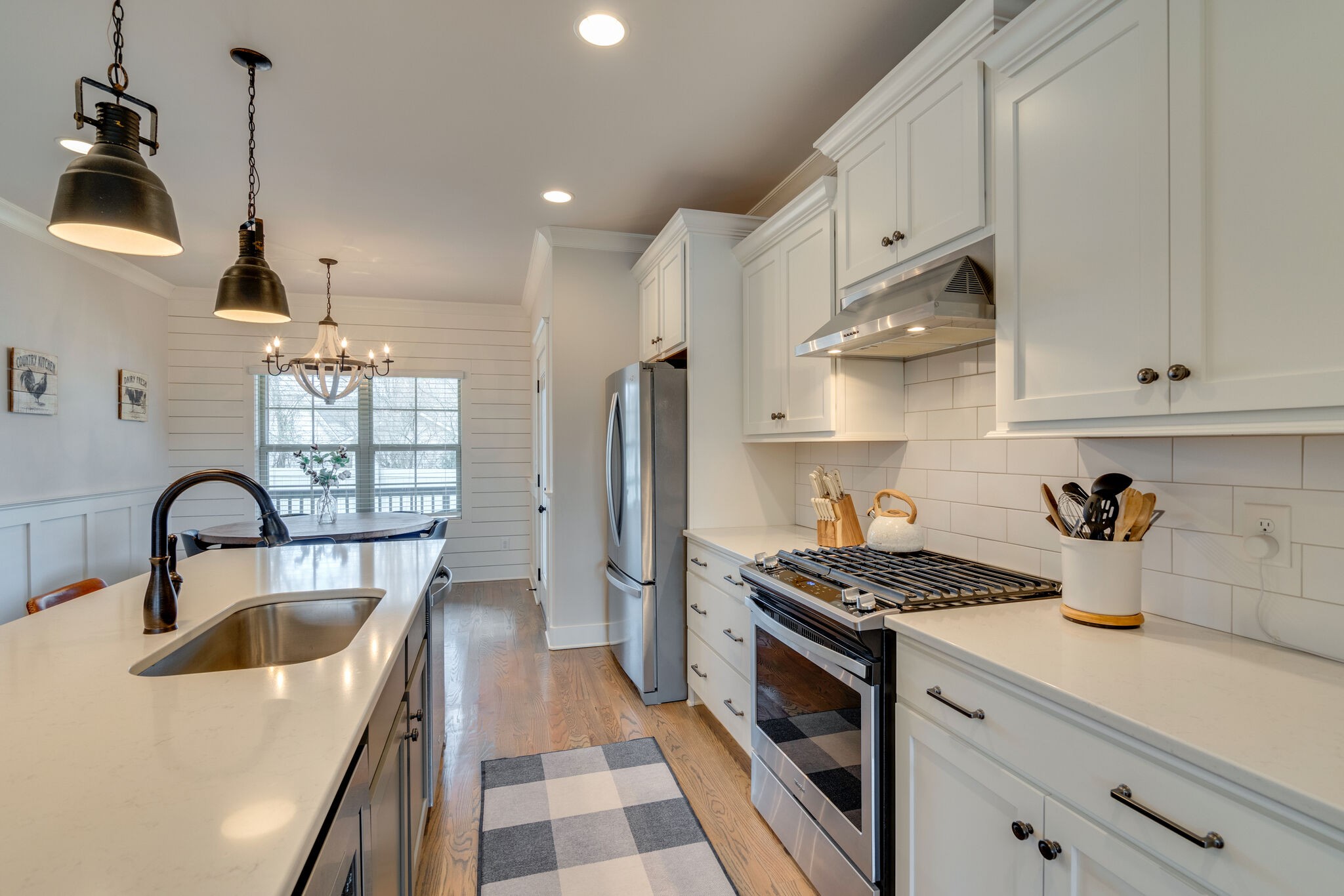 987 Carnation Drive Spring Hill, TN 37174 - Photo 8 of 26 a kitchen with stainless steel appliances granite countertop a sink stove and cabinets