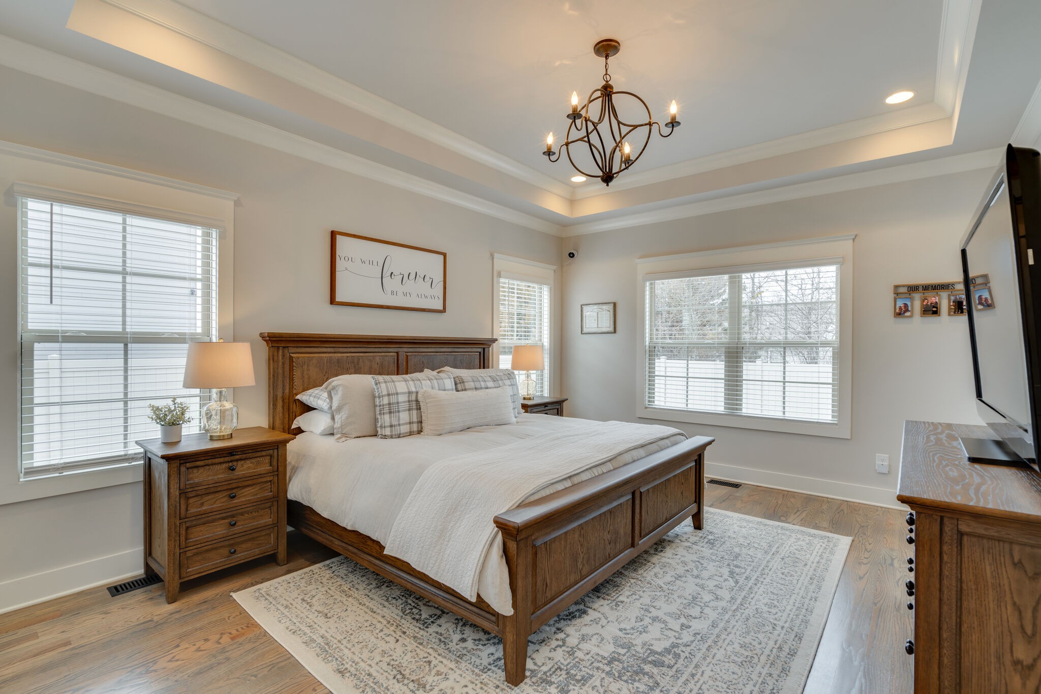 987 Carnation Drive Spring Hill, TN 37174 - Photo 10 of 26 a bedroom with a large bed and a chandelier