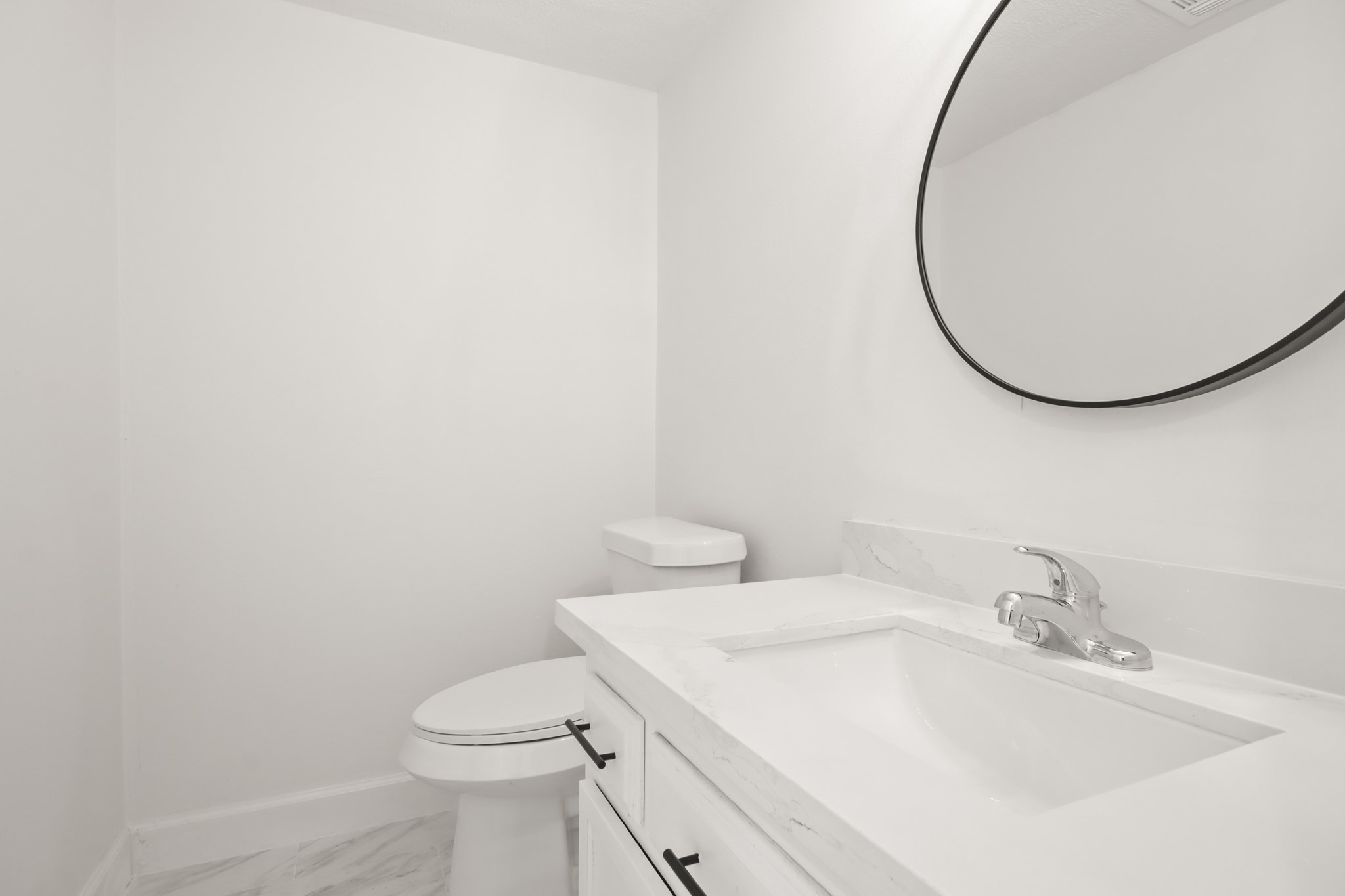 24127 Spring Fork Drive Spring, TX 77373 - Photo 3 of 17 A stylish main-level powder room offers a crisp vanity, contemporary mirror, and fresh finishes—perfectly positioned for guests.