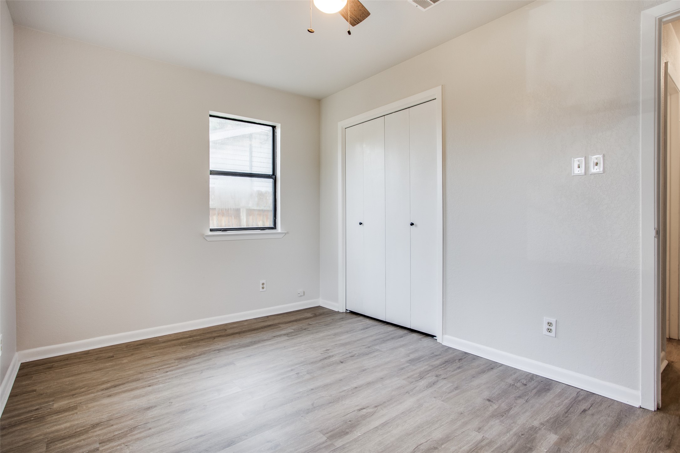 2212 Rifle Bend Drive Georgetown, TX 78626 - Photo 10 of 15 an empty room with wooden floor and windows