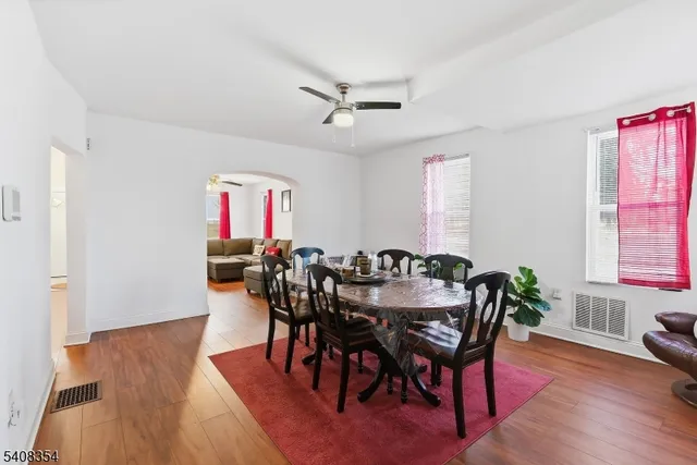a view of a a dining room with furniture window and wooden floor