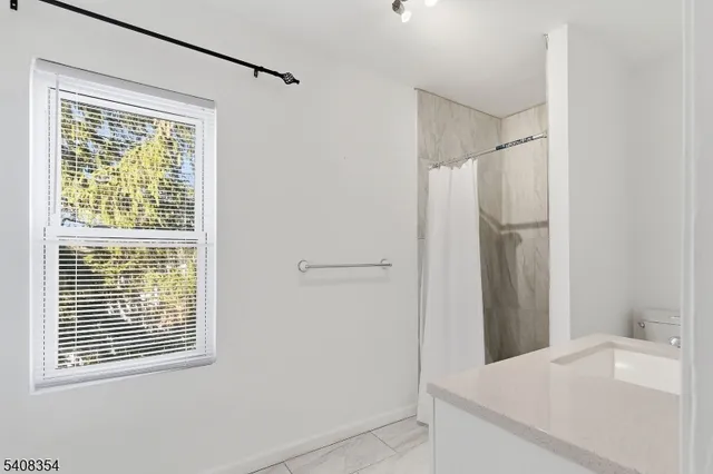 a room that has a window in it and a white sink