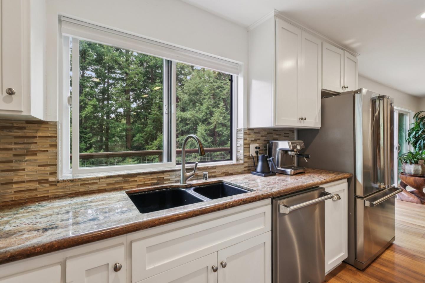 17386 Tressel Pass Road Boulder Creek, CA 95006 - Photo 11 of 41 a kitchen with a sink a counter top space cabinets and a refrigerator