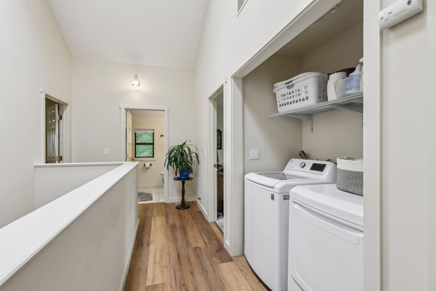 17386 Tressel Pass Road Boulder Creek, CA 95006 - Photo 13 of 41 a view of a hallway with washer and dryer